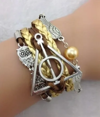 Bracciale «Bracelet Harry Potter doré hiboux triangle RDLM» — foto 1 dell'alert A12/00382/21